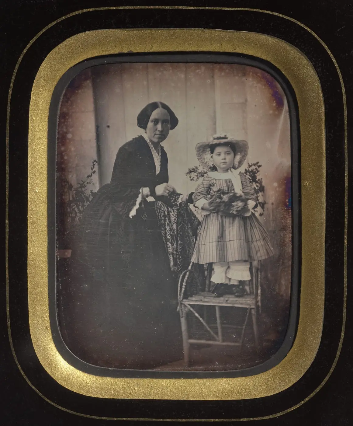 Child Standing on a Chair Holding Flowers, with Mother by Unknown artist, canvas print