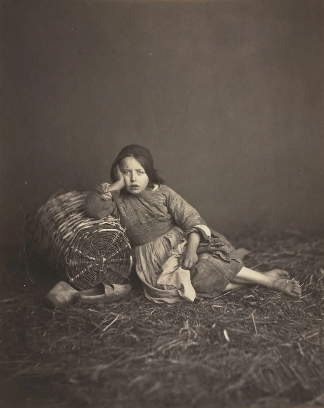 Young Girl Seated on Straw, Leaning on a Basket by Edmond Bacot, canvas print